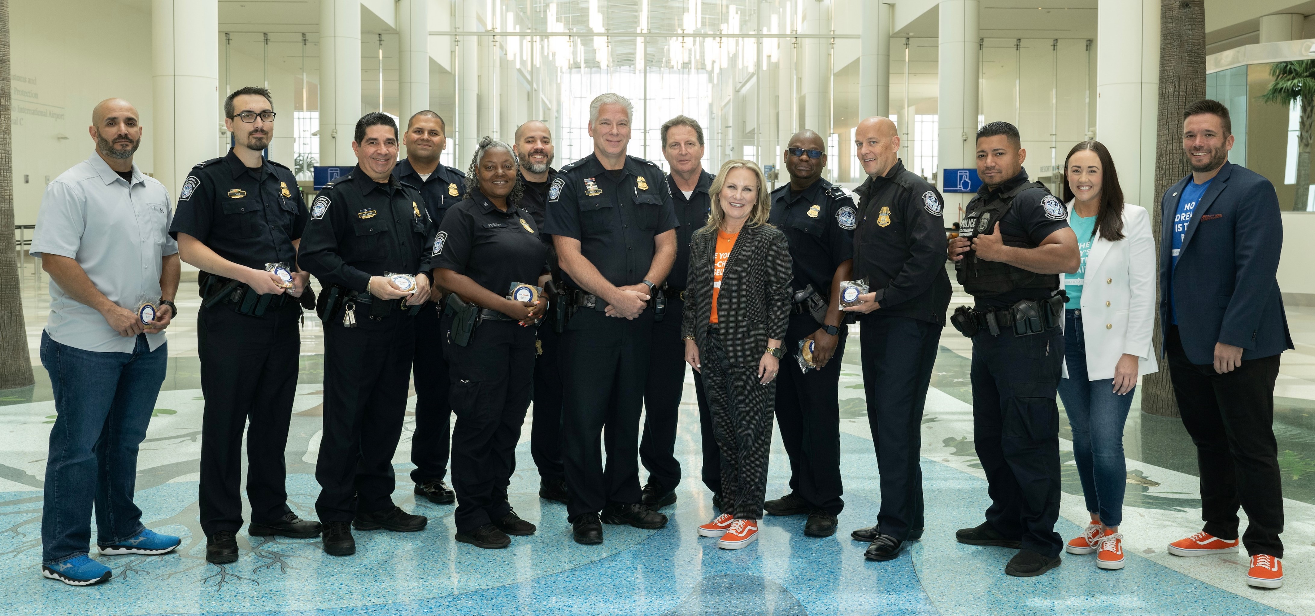 Visit Orlando's President & CEO, Casandra Matej, and Visit Orlando team members pictured with the U.S. Customs and Border Protection during National Travel & Tourism Week. 