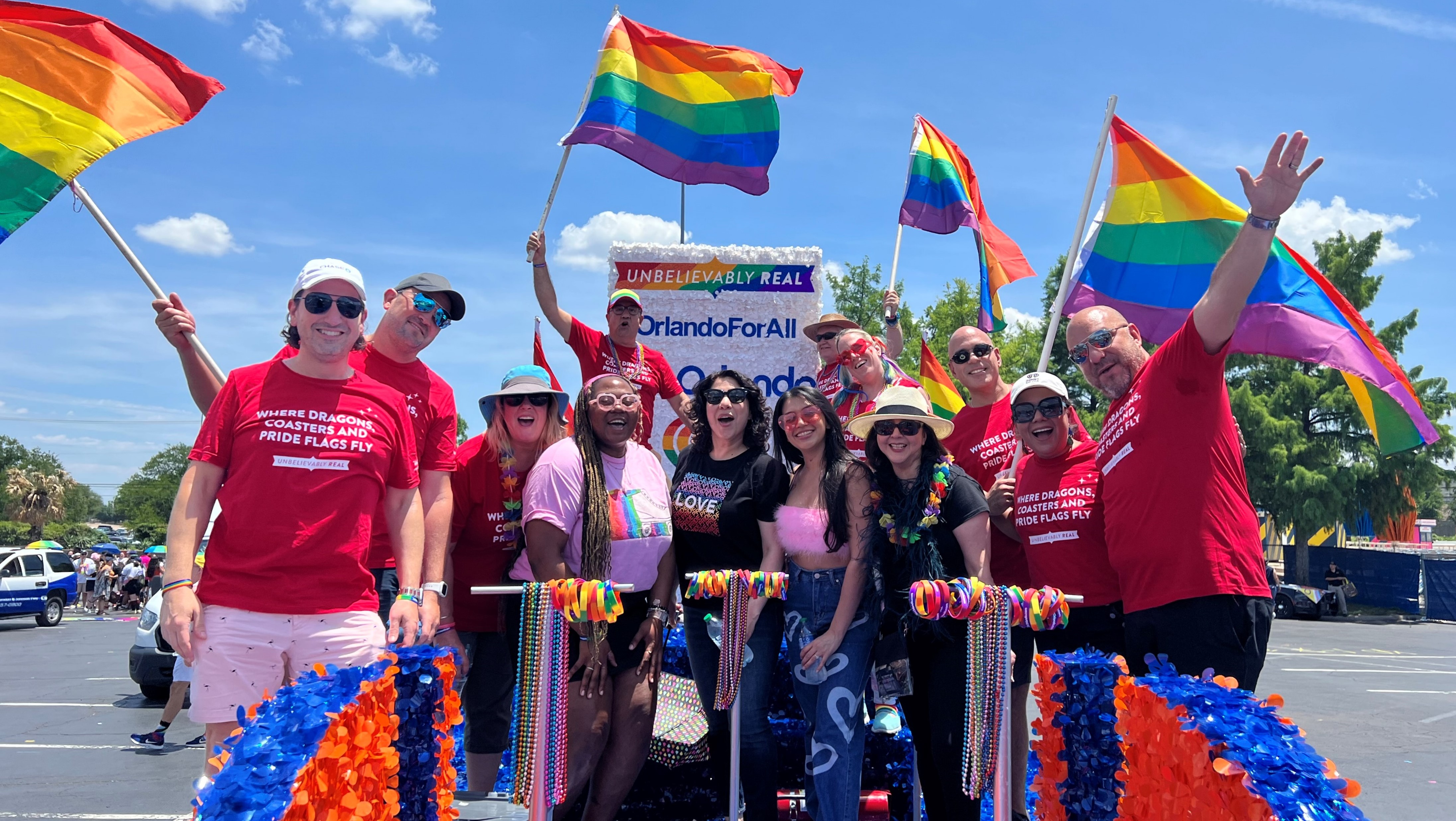 Visit Orlando team members, iHeart Media representatives and community members on an Orlando-themed parade float at the Dallas Pride Parade 2023. 